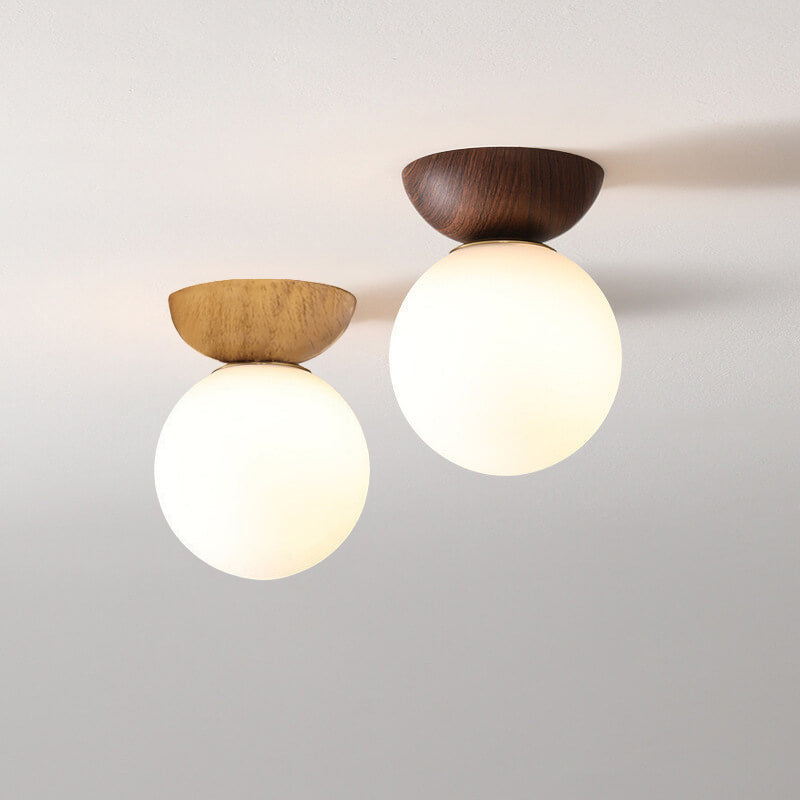 Ceiling light with glass globe and wood look in Japanese-Nordic style