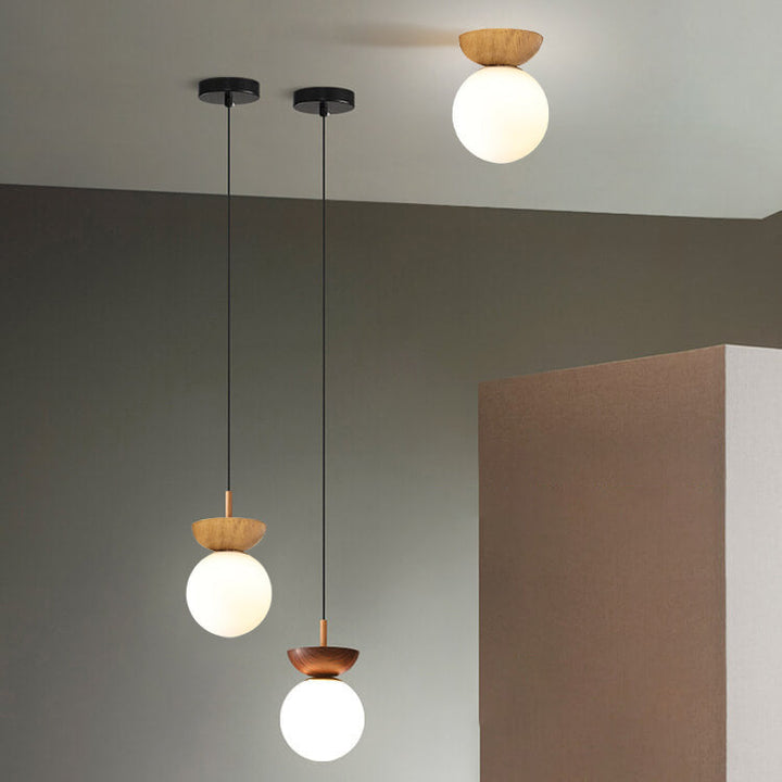 Ceiling light with glass globe and wood look in Japanese-Nordic style