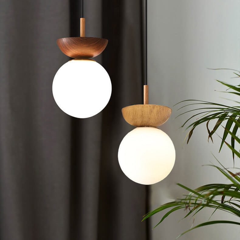 Ceiling light with glass globe and wood look in Japanese-Nordic style