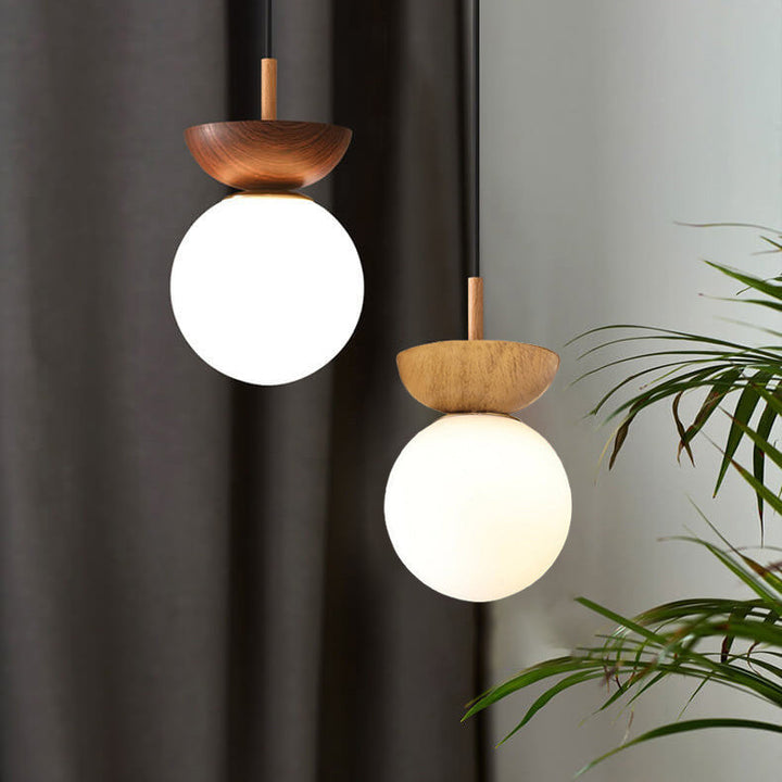 Ceiling light with glass globe and wood look in Japanese-Nordic style