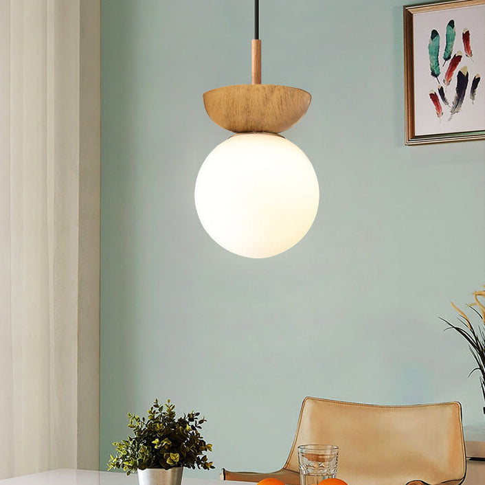 Ceiling light with glass globe and wood look in Japanese-Nordic style