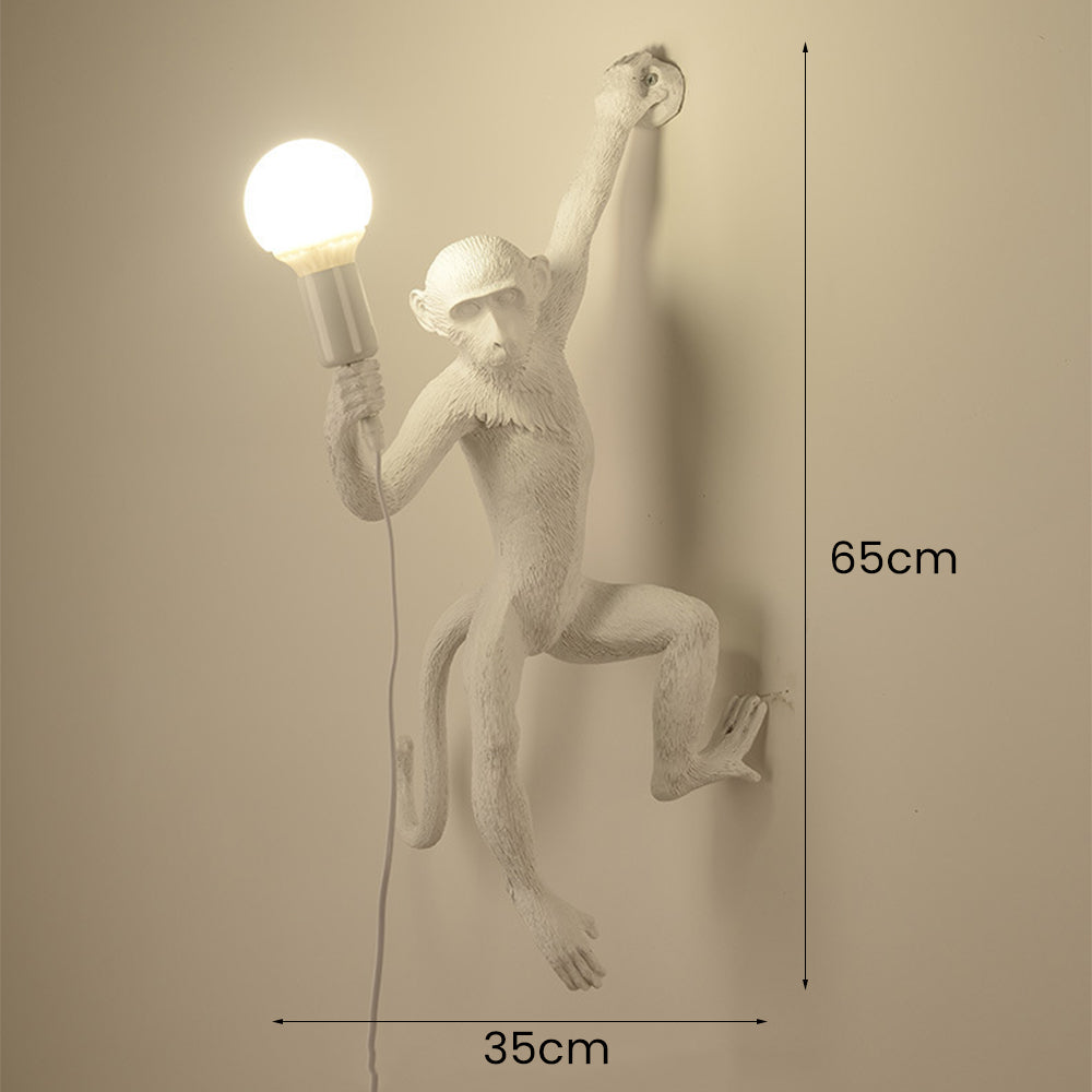 Wall lamp with playful monkey motif made of resin