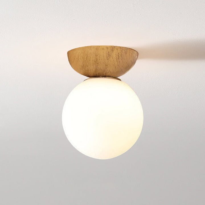 Ceiling light with glass globe and wood look in Japanese-Nordic style