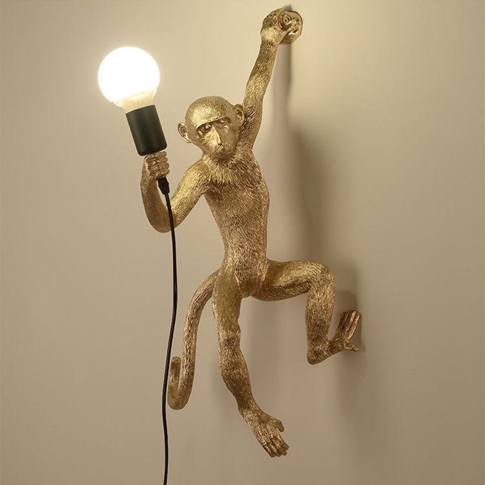 Wall lamp with playful monkey motif made of resin