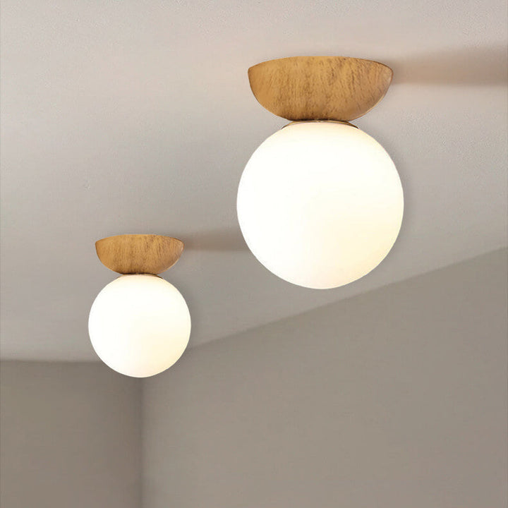 Ceiling light with glass globe and wood look in Japanese-Nordic style