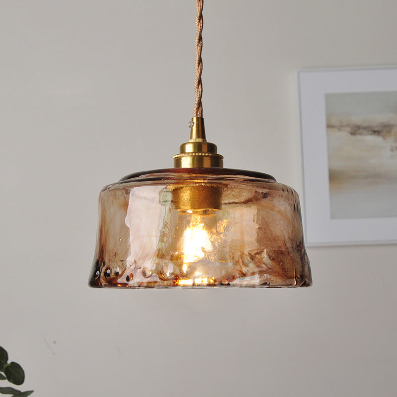 Rustic pendant light with amber-colored alabaster glass