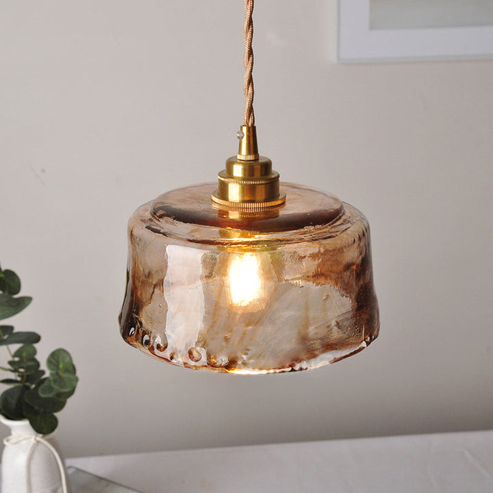 Rustic pendant light with amber-colored alabaster glass