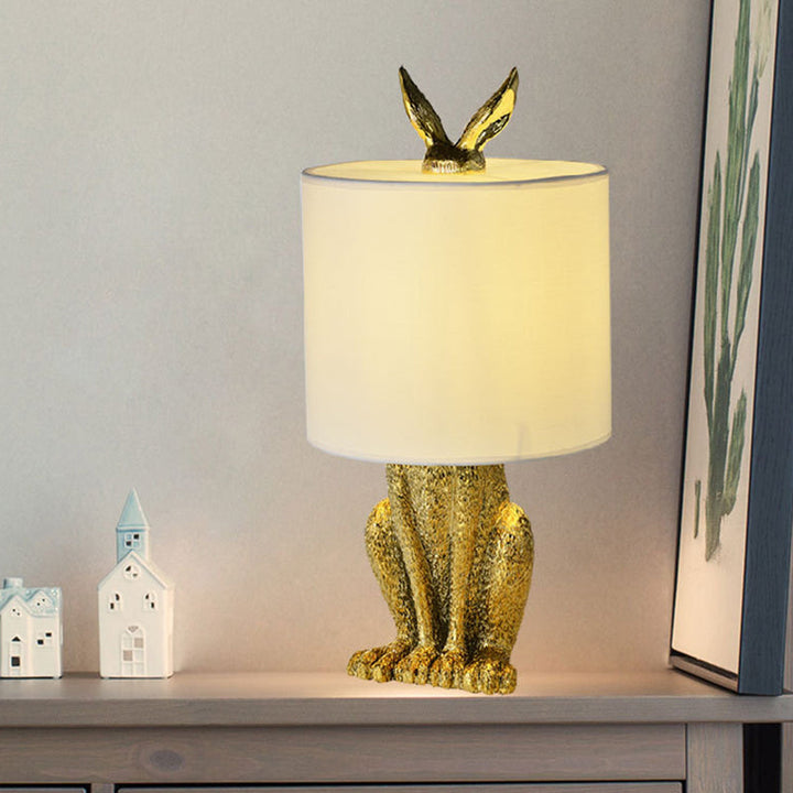 Masked Rabbit bedside lamp made of resin with fabric shade 