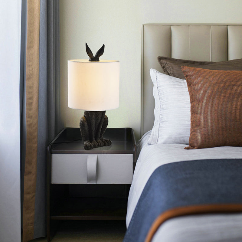 Masked Rabbit bedside lamp made of resin with fabric shade 