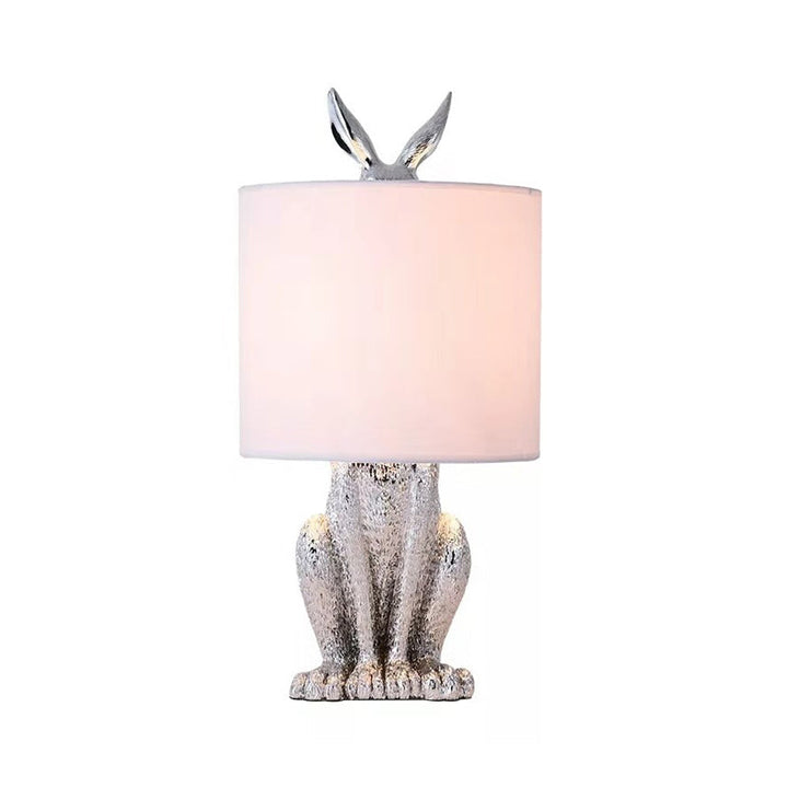Masked Rabbit bedside lamp made of resin with fabric shade 