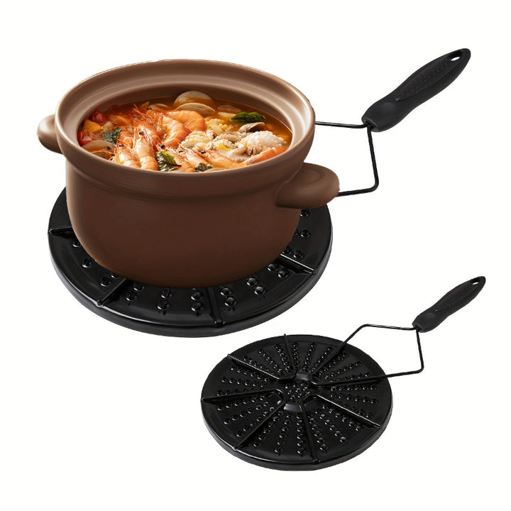 Black cast iron heat distribution pad for even cooking on a gas stove