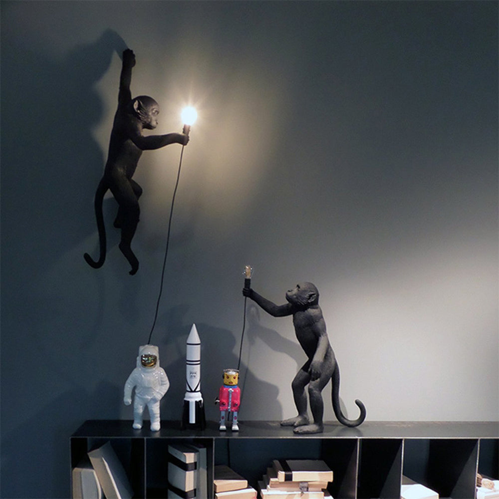 Wall lamp with playful monkey motif made of resin
