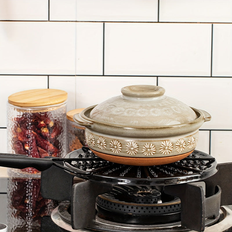 Black cast iron heat distribution pad for even cooking on a gas stove