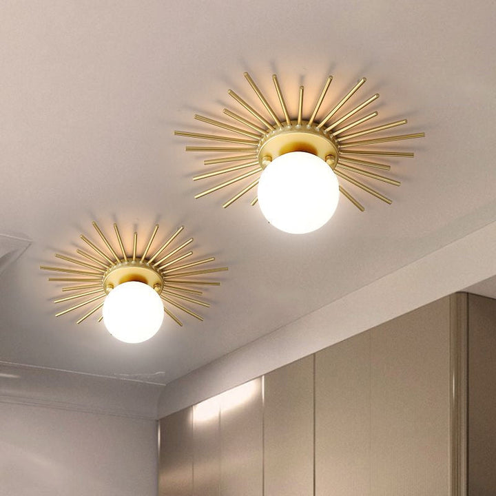 Ceiling light with frosted glass body in a gold-colored design