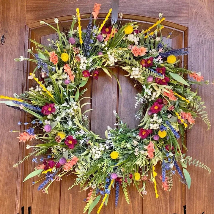 Handmade wreath with colorful artificial flowers 