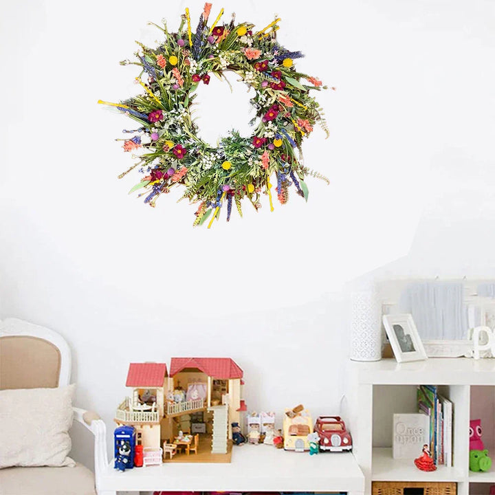 Handmade wreath with colorful artificial flowers 