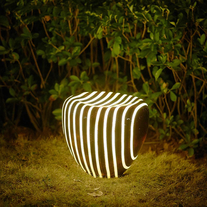 Modern weatherproof solar garden light in a stone-look design for stylish outdoor areas