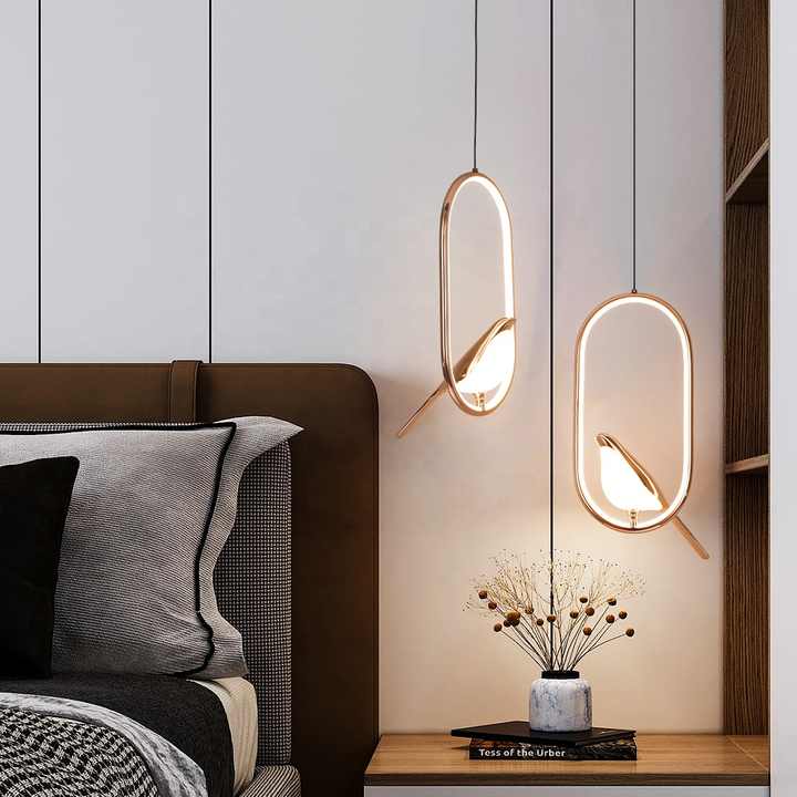 Pendant lamp with bird element and oval frame in a modern design