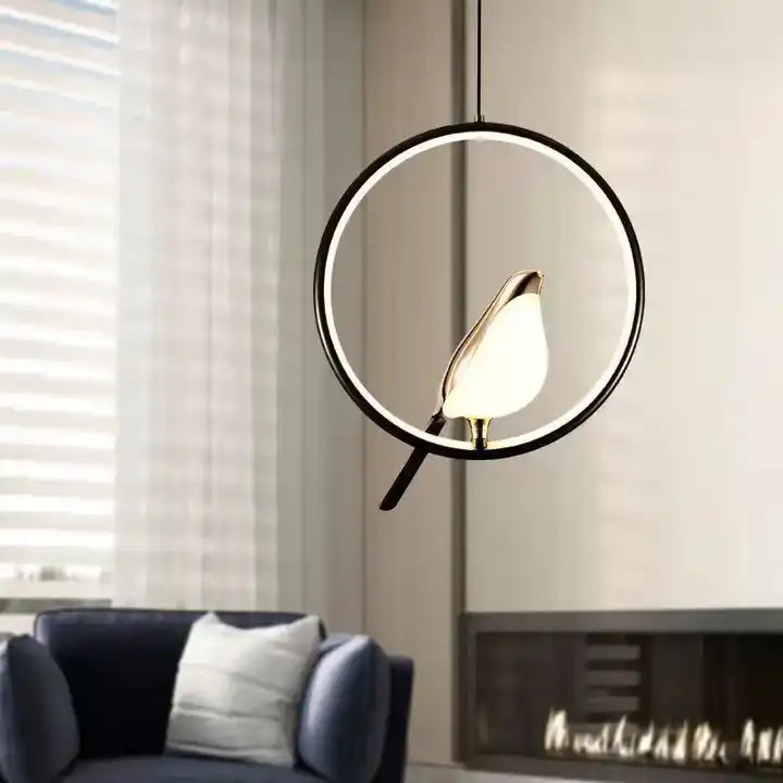 Pendant lamp with bird element and oval frame in a modern design