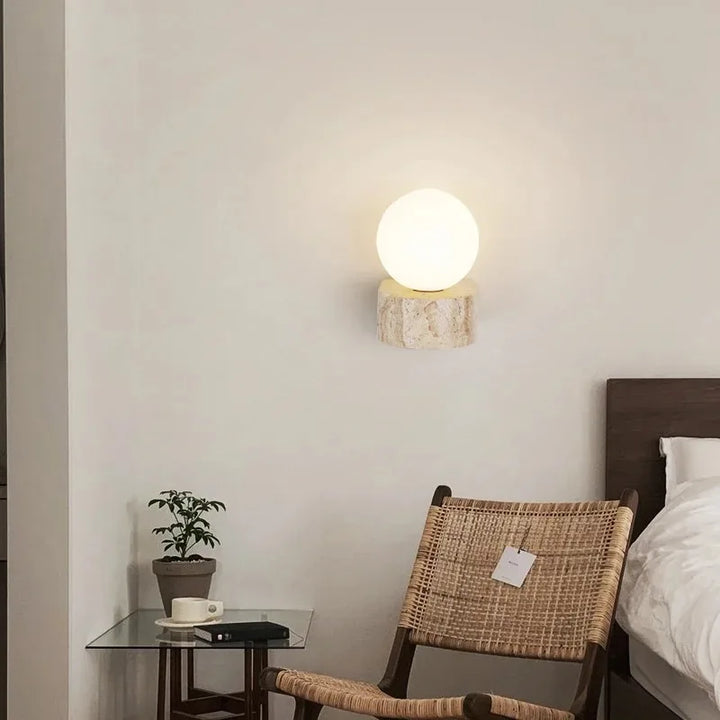LED wall light with stone base and globe glass for stylish interiors