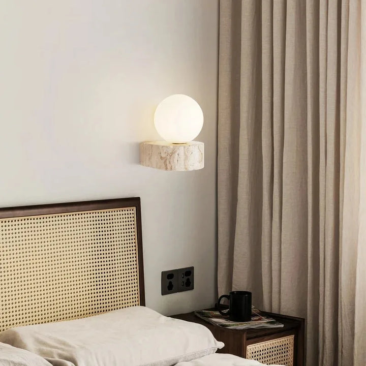LED wall light with stone base and globe glass for stylish interiors