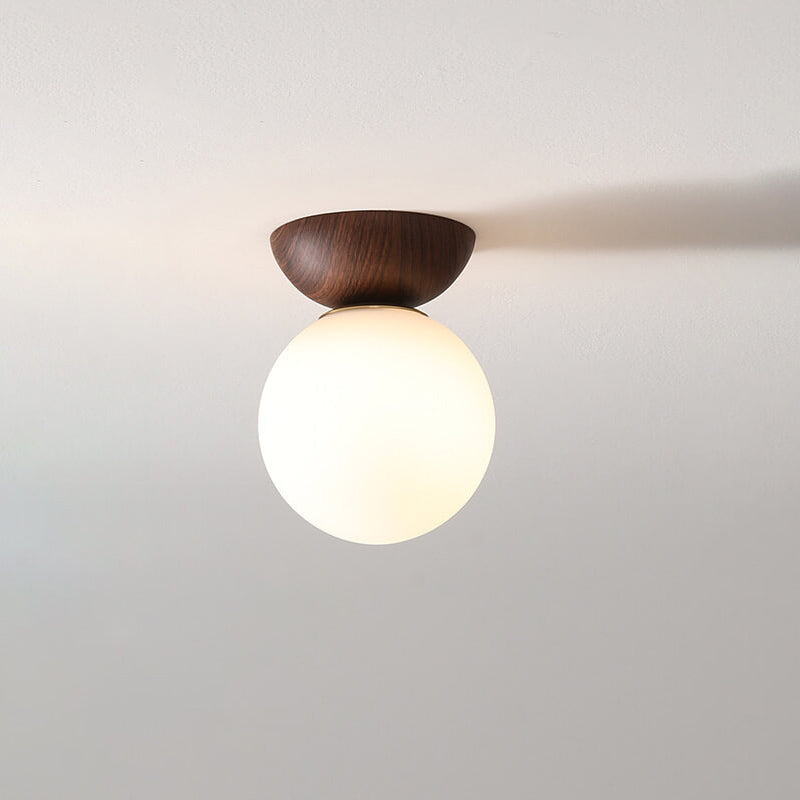 Ceiling light with glass globe and wood look in Japanese-Nordic style