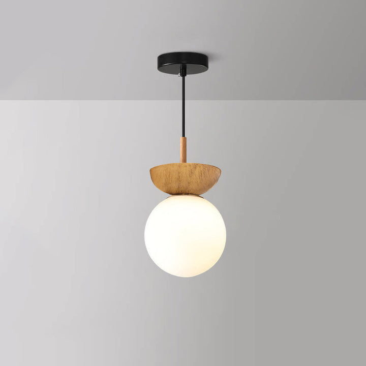 Ceiling light with glass globe and wood look in Japanese-Nordic style