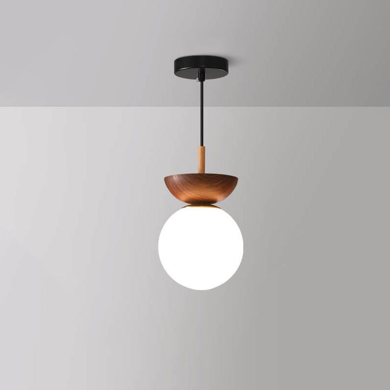 Ceiling light with glass globe and wood look in Japanese-Nordic style