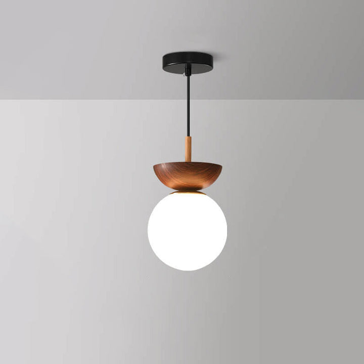 Ceiling light with glass globe and wood look in Japanese-Nordic style