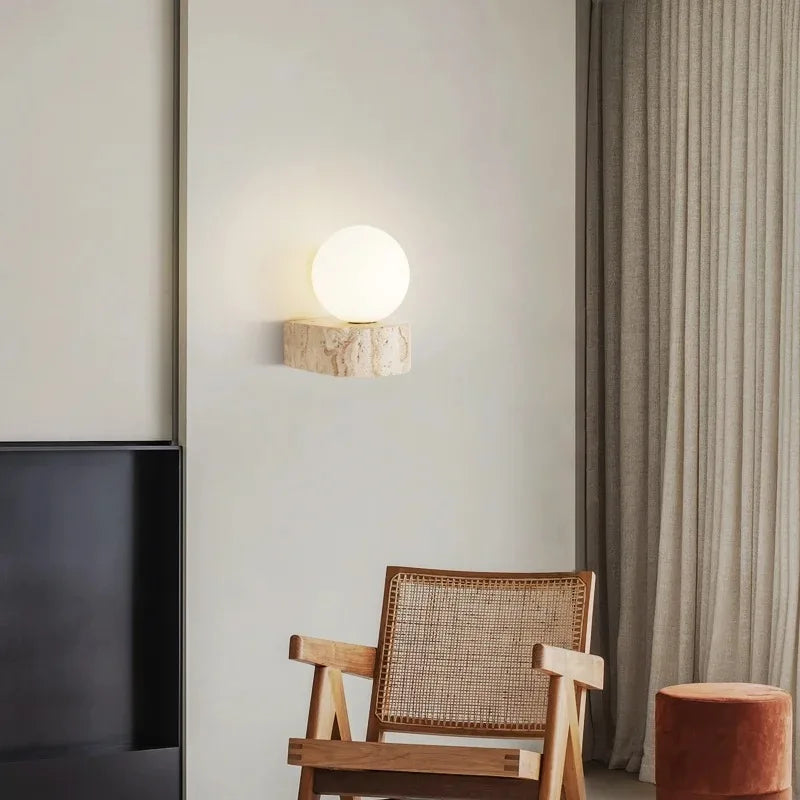 LED wall light with stone base and globe glass for stylish interiors