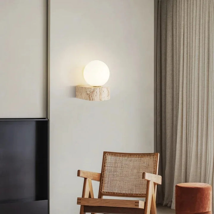 LED wall light with stone base and globe glass for stylish interiors