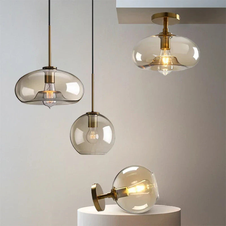 Modern ceiling light with clear glass shade and brass details