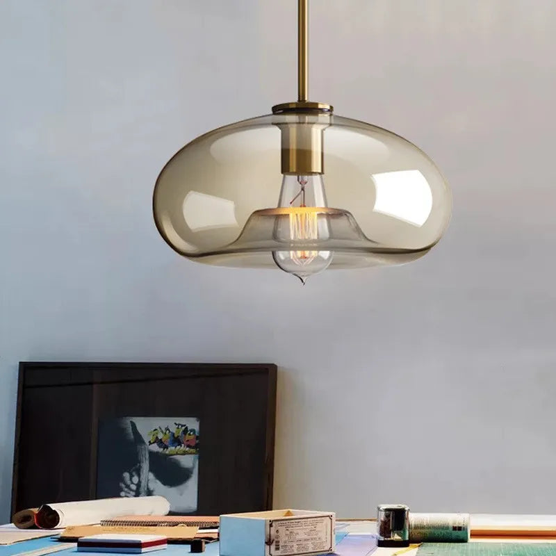 Modern ceiling light with clear glass shade and brass details