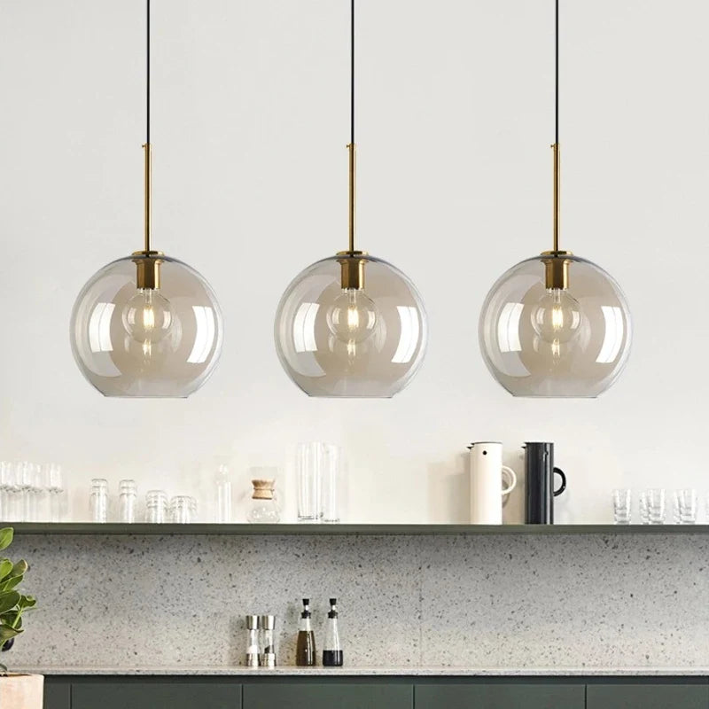 Modern ceiling light with clear glass shade and brass details
