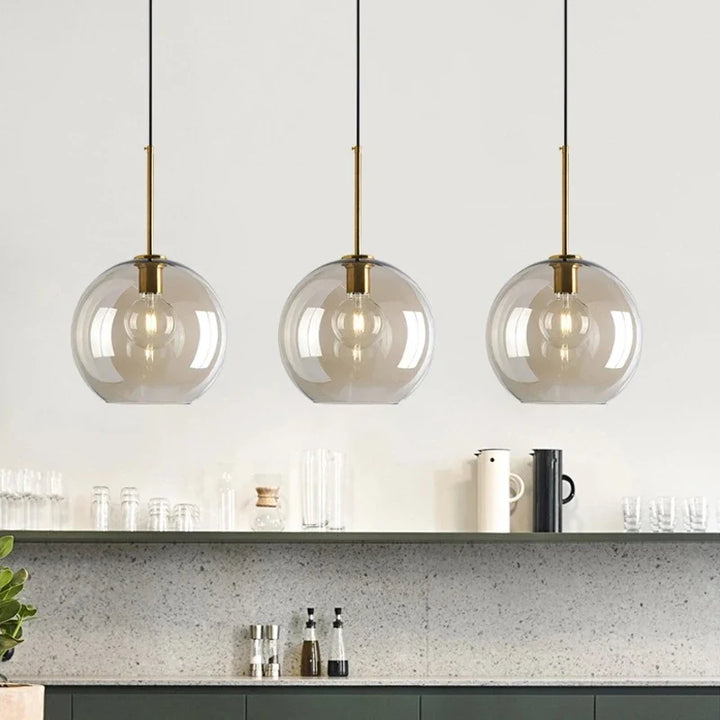 Modern ceiling light with clear glass shade and brass details