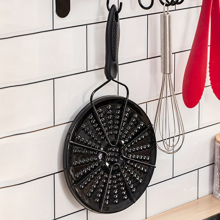Black cast iron heat distribution pad for even cooking on a gas stove