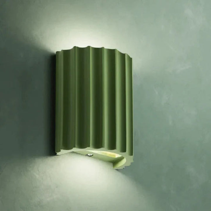 Modern LED wall light in a ribbed cylindrical shape for indoor use