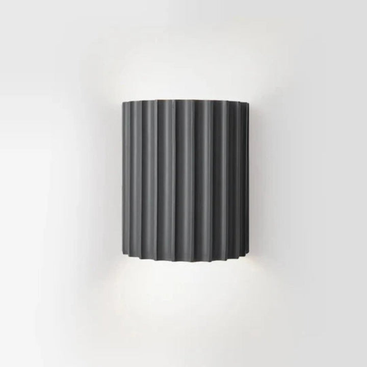 Modern LED wall light in a ribbed cylindrical shape for indoor use