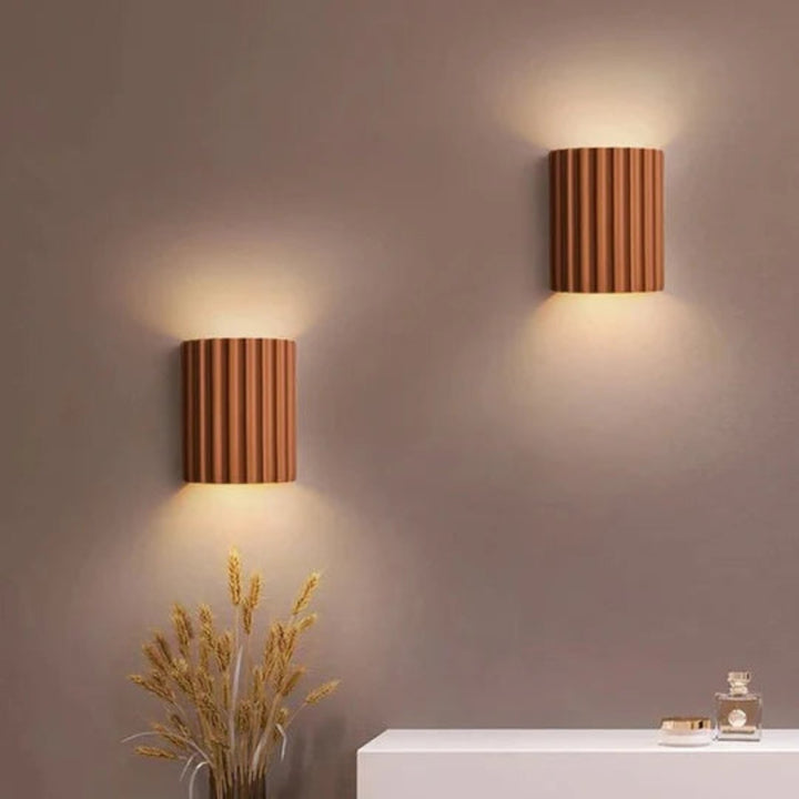 Modern LED wall light in a ribbed cylindrical shape for indoor use