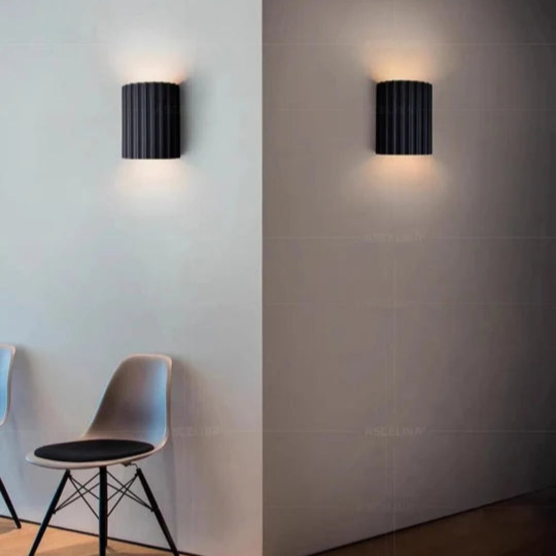 Modern LED wall light in a ribbed cylindrical shape for indoor use