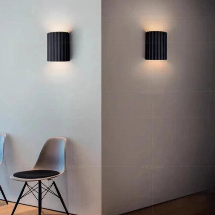 Modern LED wall light in a ribbed cylindrical shape for indoor use