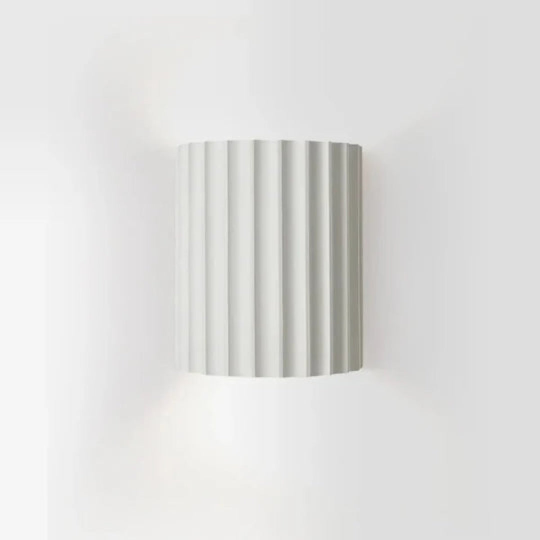 Modern LED wall light in a ribbed cylindrical shape for indoor use